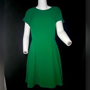 Limited short sleeve, knee length dress in Emerald green, pleats, size 2.